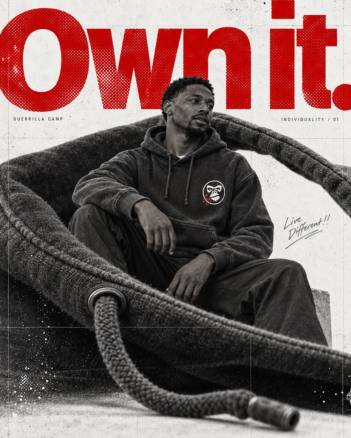 A seated adult in the charcoal GC Hoodie, framed by an oversized hood, with red halftone Own it typography.